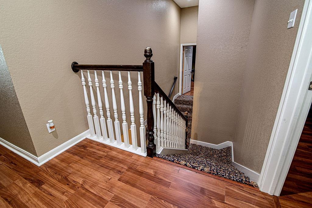 9801 Bellechase Road Granbury, TX 76049 - Photo 29 of 40 a view of a hallway with wooden floor and staircase