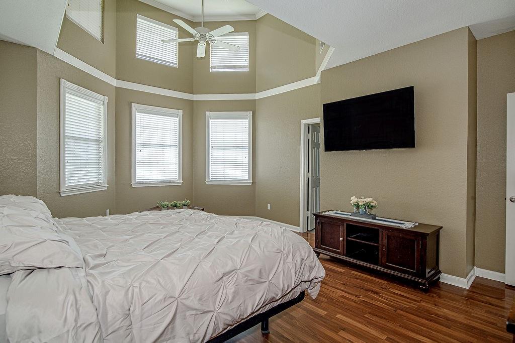 9801 Bellechase Road Granbury, TX 76049 - Photo 36 of 40 a bedroom with a bed and a flat screen tv