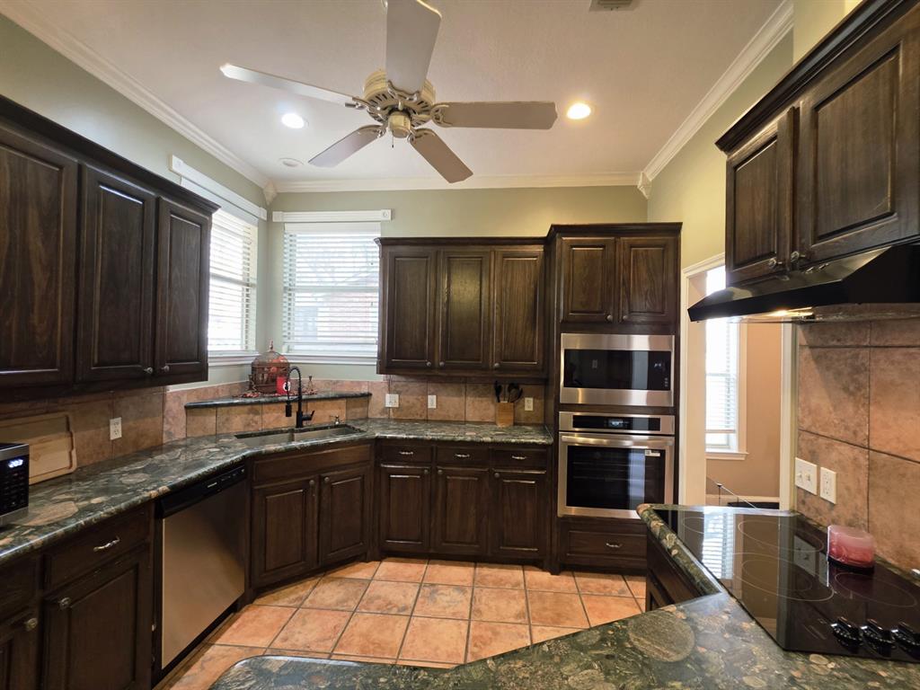 9801 Bellechase Road Granbury, TX 76049 - Photo 39 of 40 a kitchen with a sink stove and refrigerator