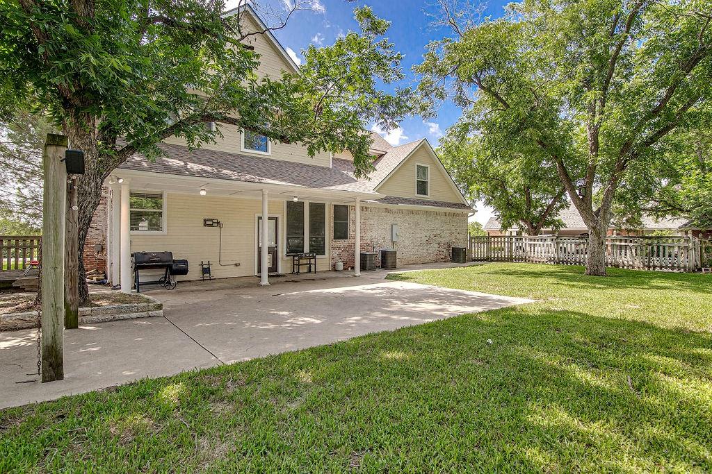 9801 Bellechase Road Granbury, TX 76049 - Photo 8 of 40 a view of a house with a yard and large tree