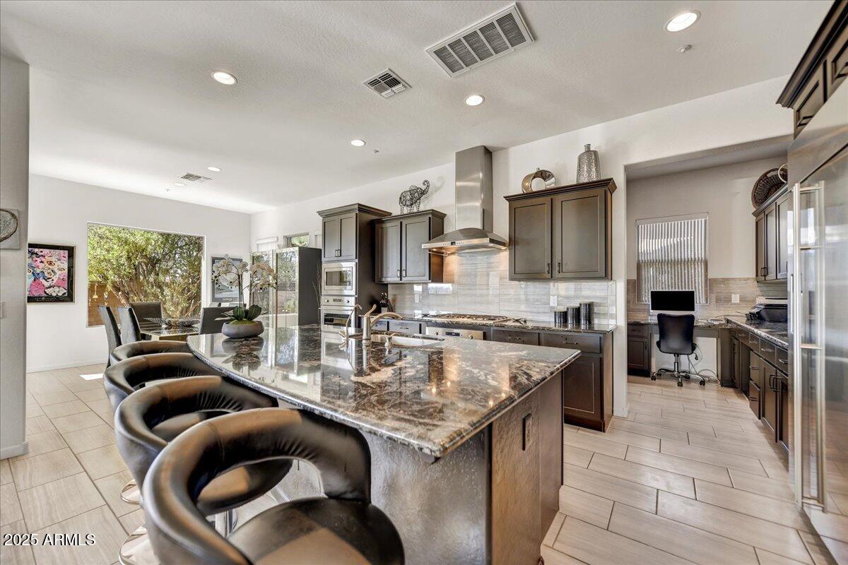 17943 East Silver Sage Lane Rio Verde, AZ 85263 - Photo 11 of 66 a kitchen with stainless steel appliances granite countertop lots of counter top space and refrigerator