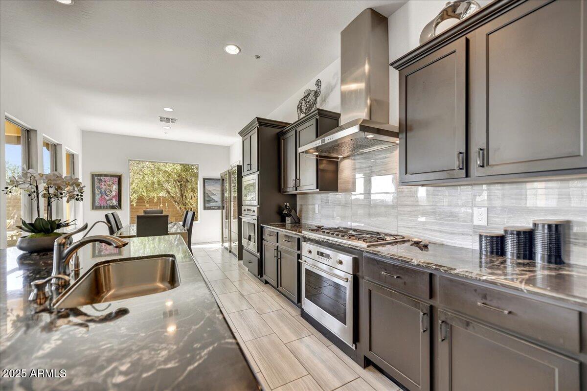 17943 East Silver Sage Lane Rio Verde, AZ 85263 - Photo 13 of 66 a kitchen with stainless steel appliances granite countertop a sink a stove and a refrigerator