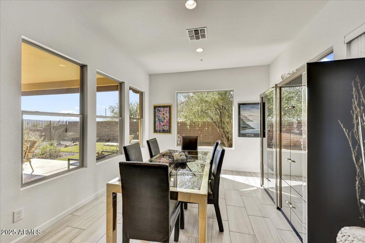17943 East Silver Sage Lane Rio Verde, AZ 85263 - Photo 16 of 66 a view of a dining room with furniture and a window