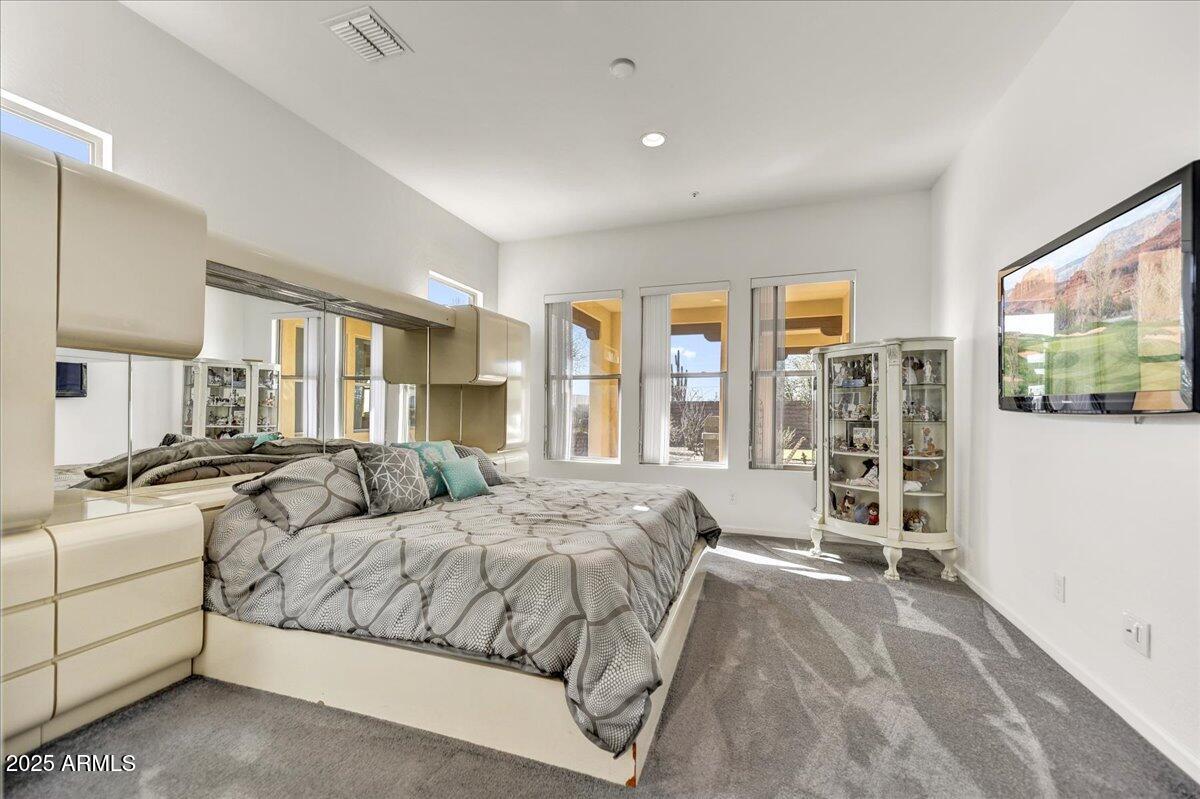 17943 East Silver Sage Lane Rio Verde, AZ 85263 - Photo 17 of 66 a spacious bedroom with a large bed and a large window