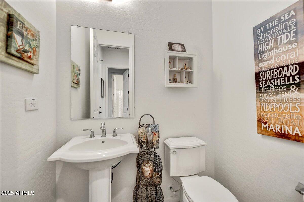 17943 East Silver Sage Lane Rio Verde, AZ 85263 - Photo 23 of 66 a bathroom with a toilet sink and mirror