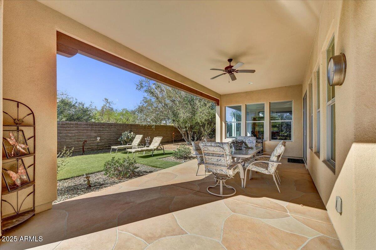 17943 East Silver Sage Lane Rio Verde, AZ 85263 - Photo 25 of 66 a living room with a floor to ceiling window and a table