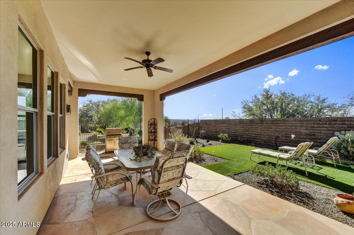 17943 East Silver Sage Lane Rio Verde, AZ 85263 - Photo 26 of 66 a view of a patio with a dining table and chairs
