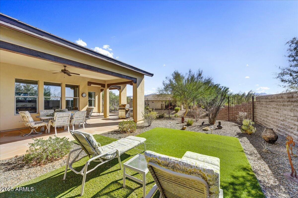 17943 East Silver Sage Lane Rio Verde, AZ 85263 - Photo 29 of 66 a view of a chair and tables in the patio