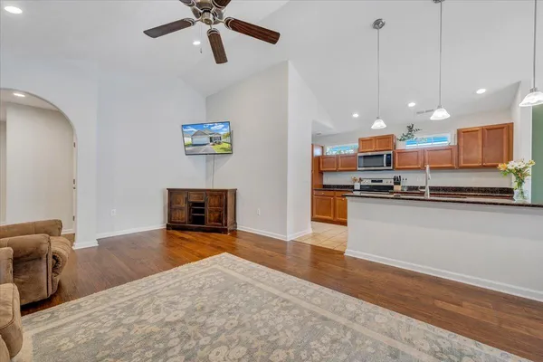 a living room with furniture and a wooden floor