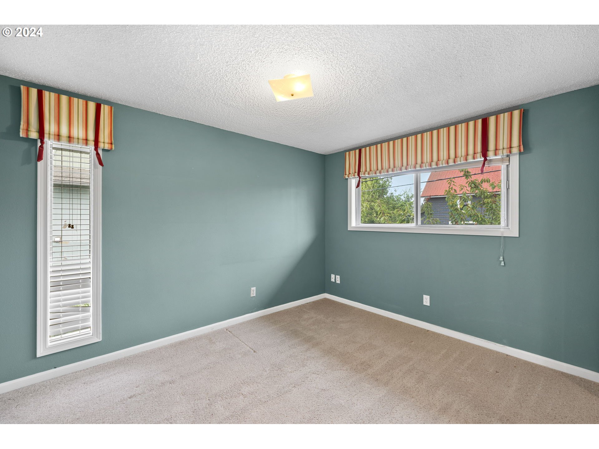 12871 Southeast Stark Street, Unit A16 Portland, OR 97233 - Photo 14 of 20 a view of an empty room with a window
