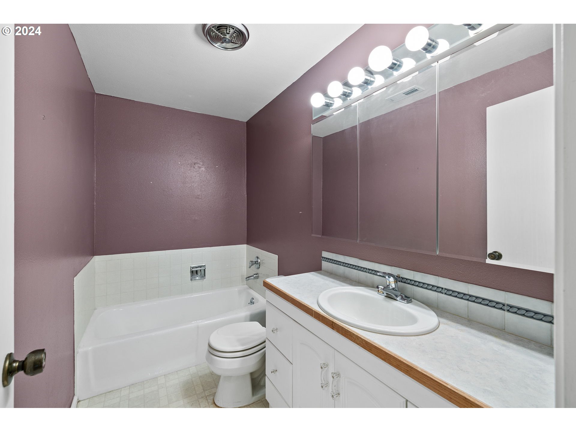 12871 Southeast Stark Street, Unit A16 Portland, OR 97233 - Photo 16 of 20 a bathroom with a granite countertop sink mirror vanity and toilet