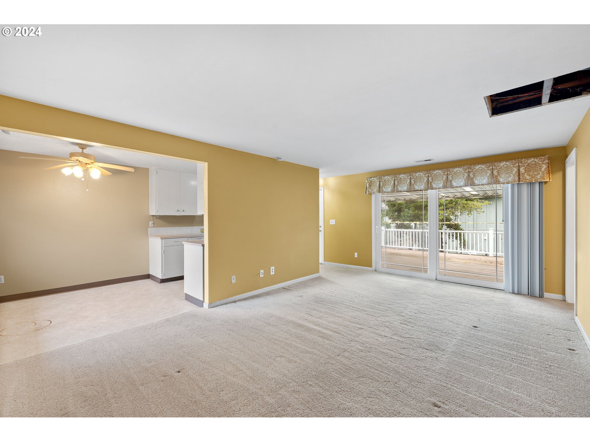 12871 Southeast Stark Street, Unit A16 Portland, OR 97233 - Photo 4 of 20 a view of an empty room with a window