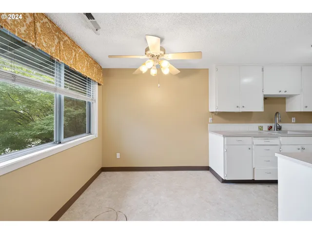 a kitchen with a sink cabinets and window