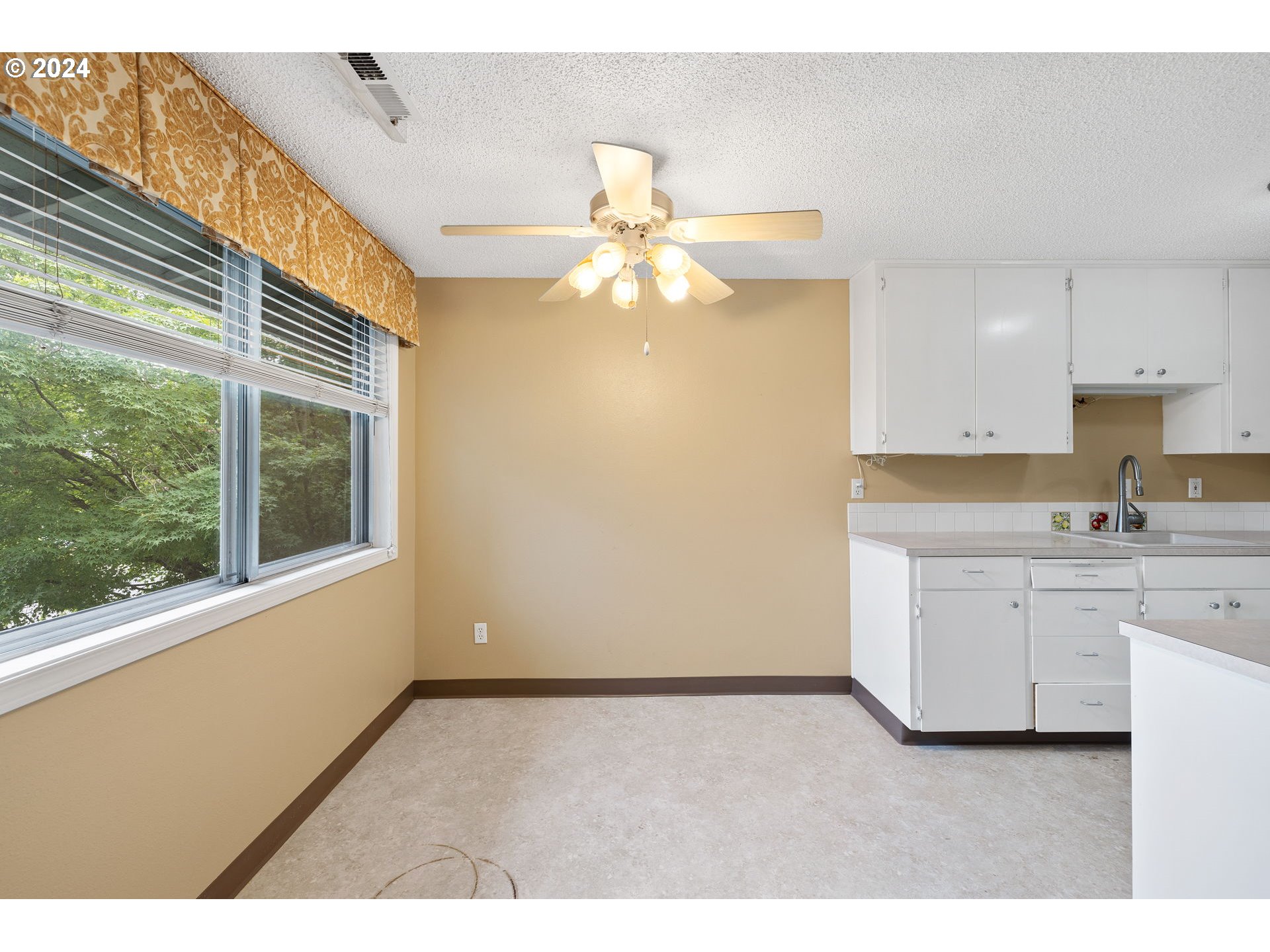 12871 Southeast Stark Street, Unit A16 Portland, OR 97233 - Photo 5 of 20 a kitchen with a sink cabinets and window