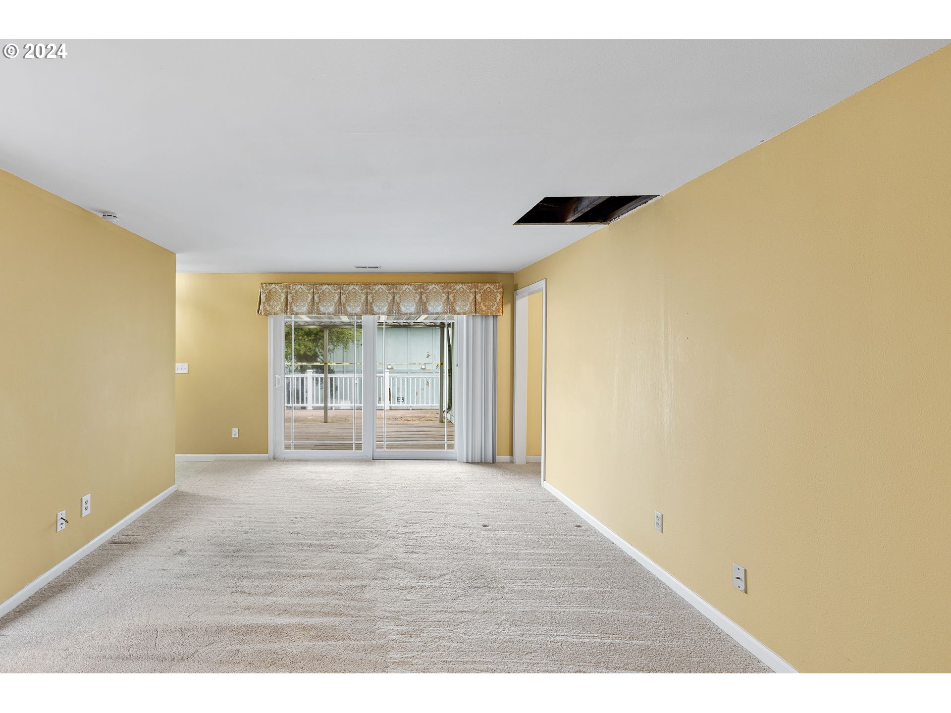 12871 Southeast Stark Street, Unit A16 Portland, OR 97233 - Photo 9 of 20 a view of an empty room with a window