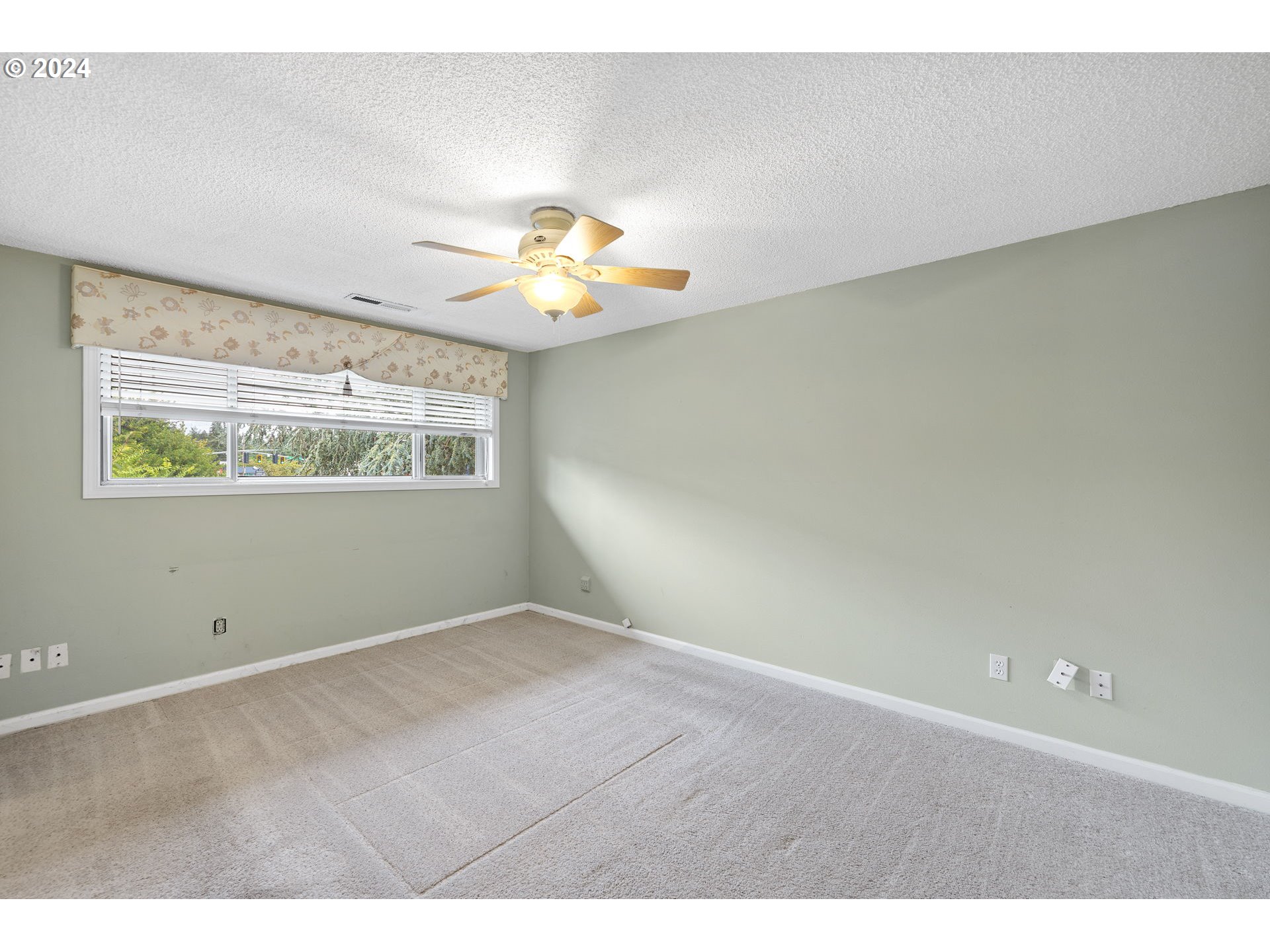 12871 Southeast Stark Street, Unit A16 Portland, OR 97233 - Photo 10 of 20 a view of an empty room with a window