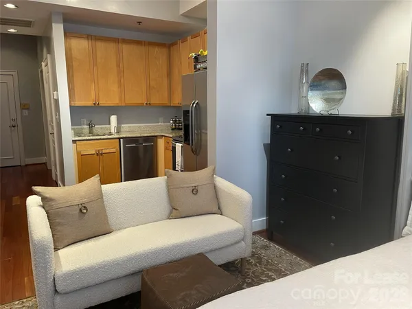 a kitchen with a sink a refrigerator and cabinets