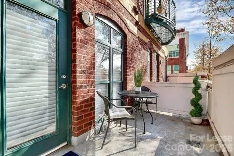 a view of a patio with a table and chairs and potted plants