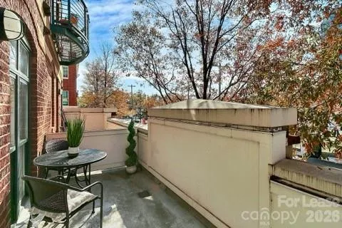 a view of a patio with table and chairs and potted plants