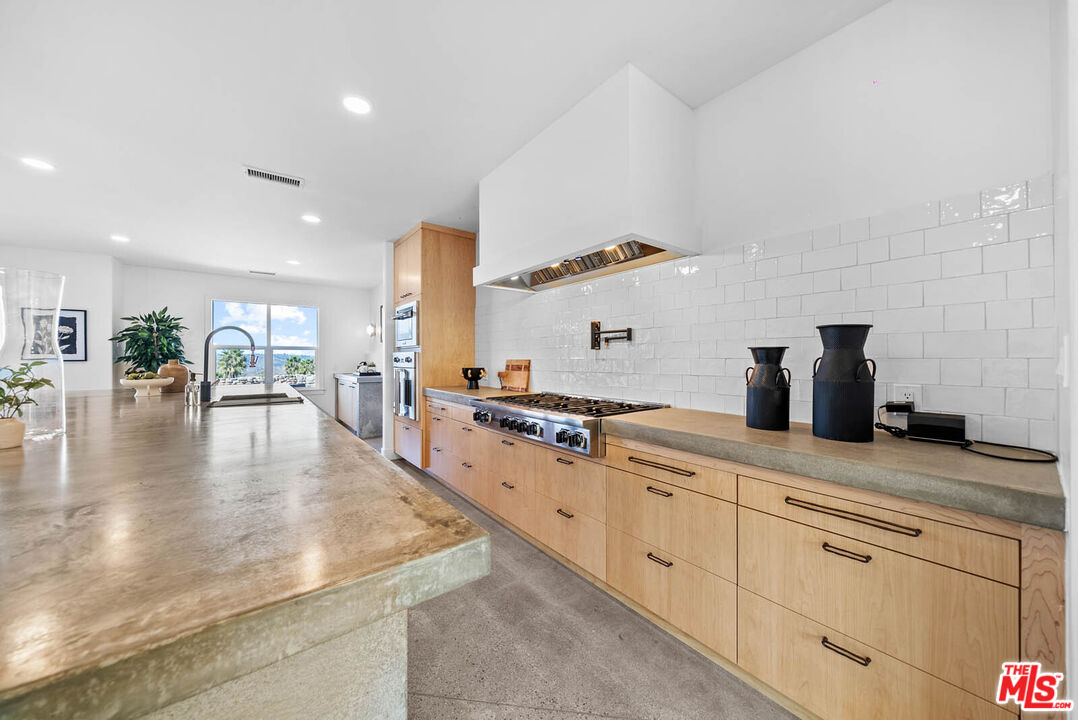32070 Vía Vera Bonsall, CA 92003 - Photo 11 of 75 a kitchen with white cabinets and sink