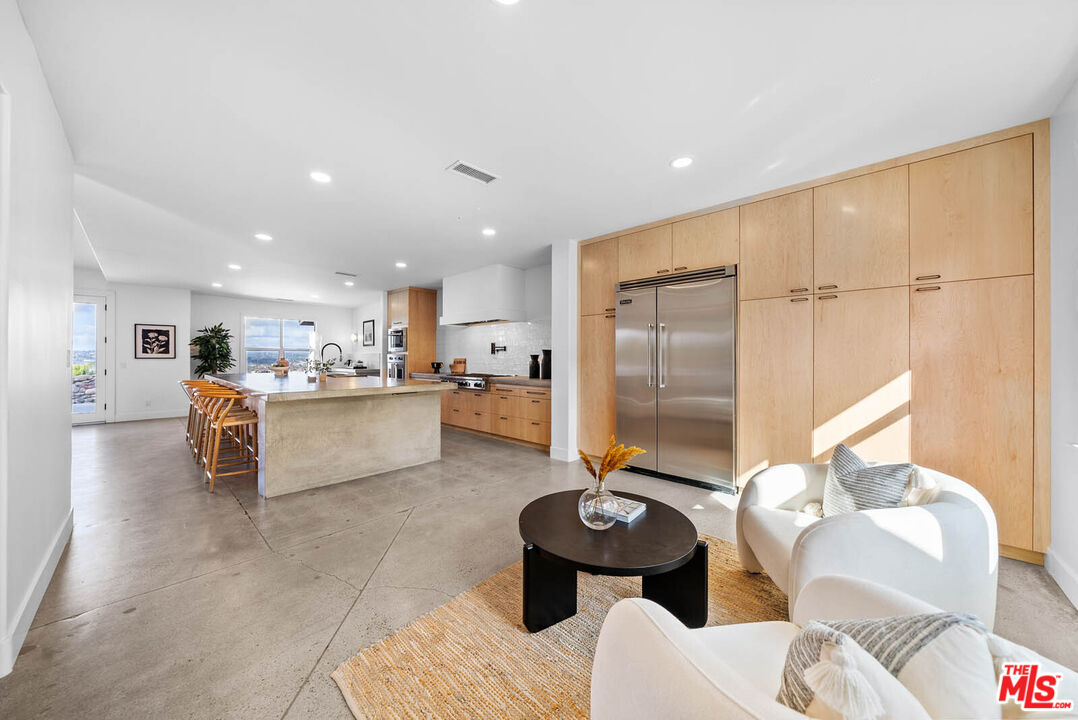 32070 Vía Vera Bonsall, CA 92003 - Photo 18 of 75 a living room with furniture and kitchen view