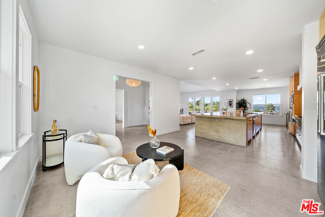 32070 Vía Vera Bonsall, CA 92003 - Photo 36 of 75 a living room with furniture and kitchen view