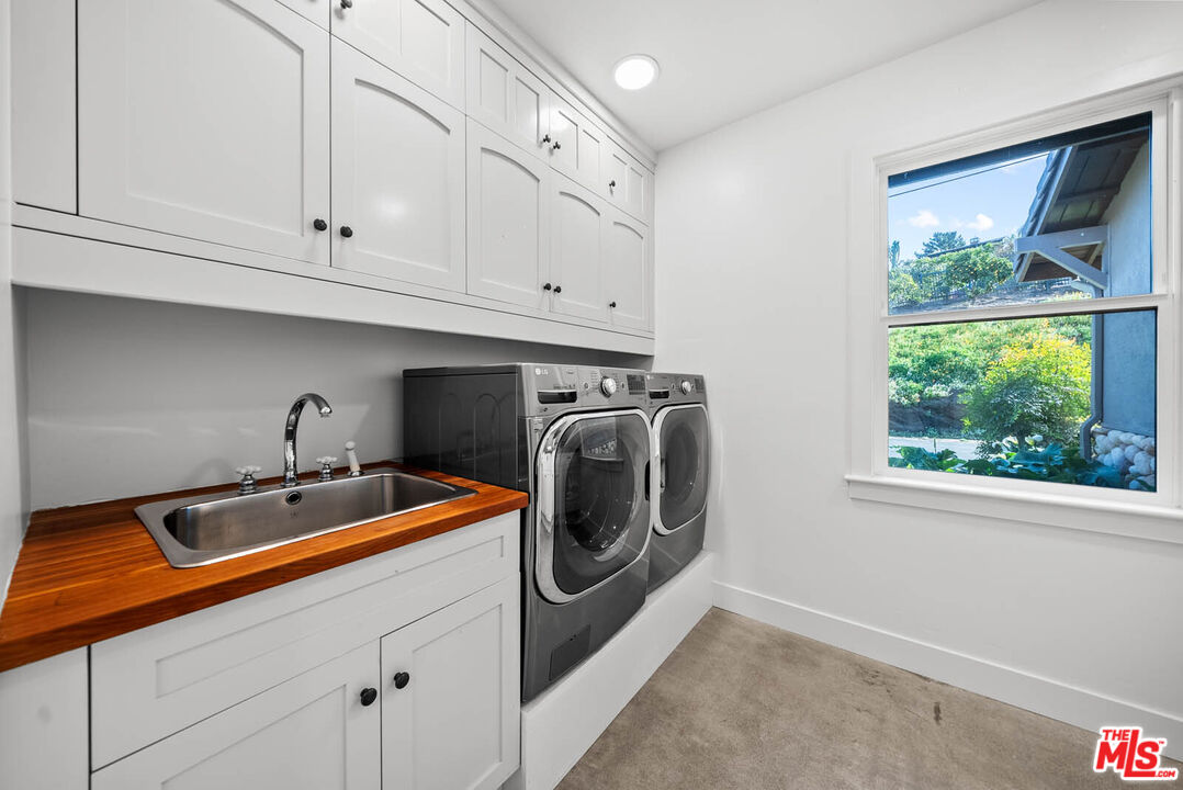 32070 Vía Vera Bonsall, CA 92003 - Photo 43 of 75 a utility room with sink dryer and washer