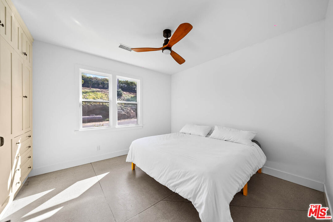 32070 Vía Vera Bonsall, CA 92003 - Photo 49 of 75 a bedroom with a bed and a window