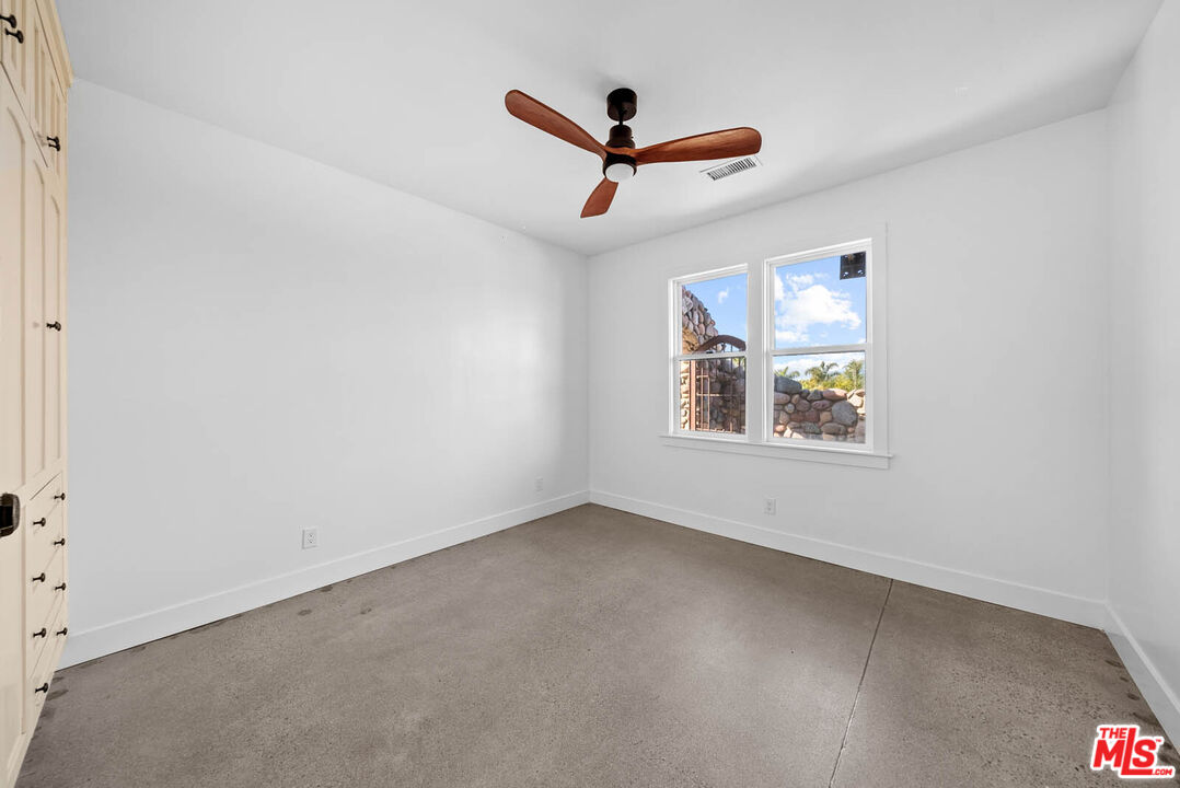 32070 Vía Vera Bonsall, CA 92003 - Photo 53 of 75 an empty room with ceiling fan and window