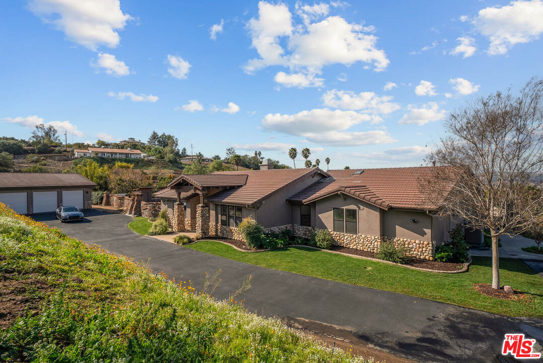 32070 Vía Vera Bonsall, CA 92003 - Photo 55 of 75 a front view of a house with a yard
