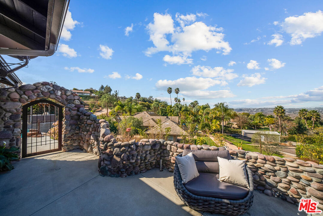 32070 Vía Vera Bonsall, CA 92003 - Photo 61 of 75 a view of a terrace with couches and a potted plant