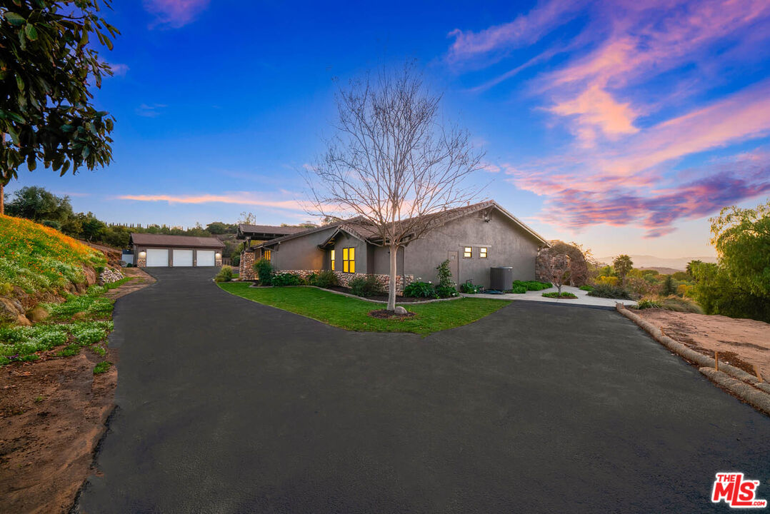 32070 Vía Vera Bonsall, CA 92003 - Photo 68 of 75 a view of a street with a building in the background