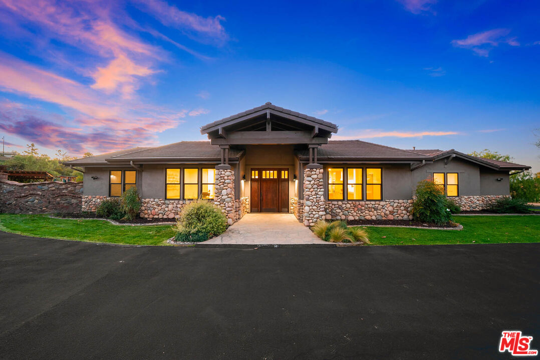 32070 Vía Vera Bonsall, CA 92003 - Photo 7 of 75 a front view of a house with a yard