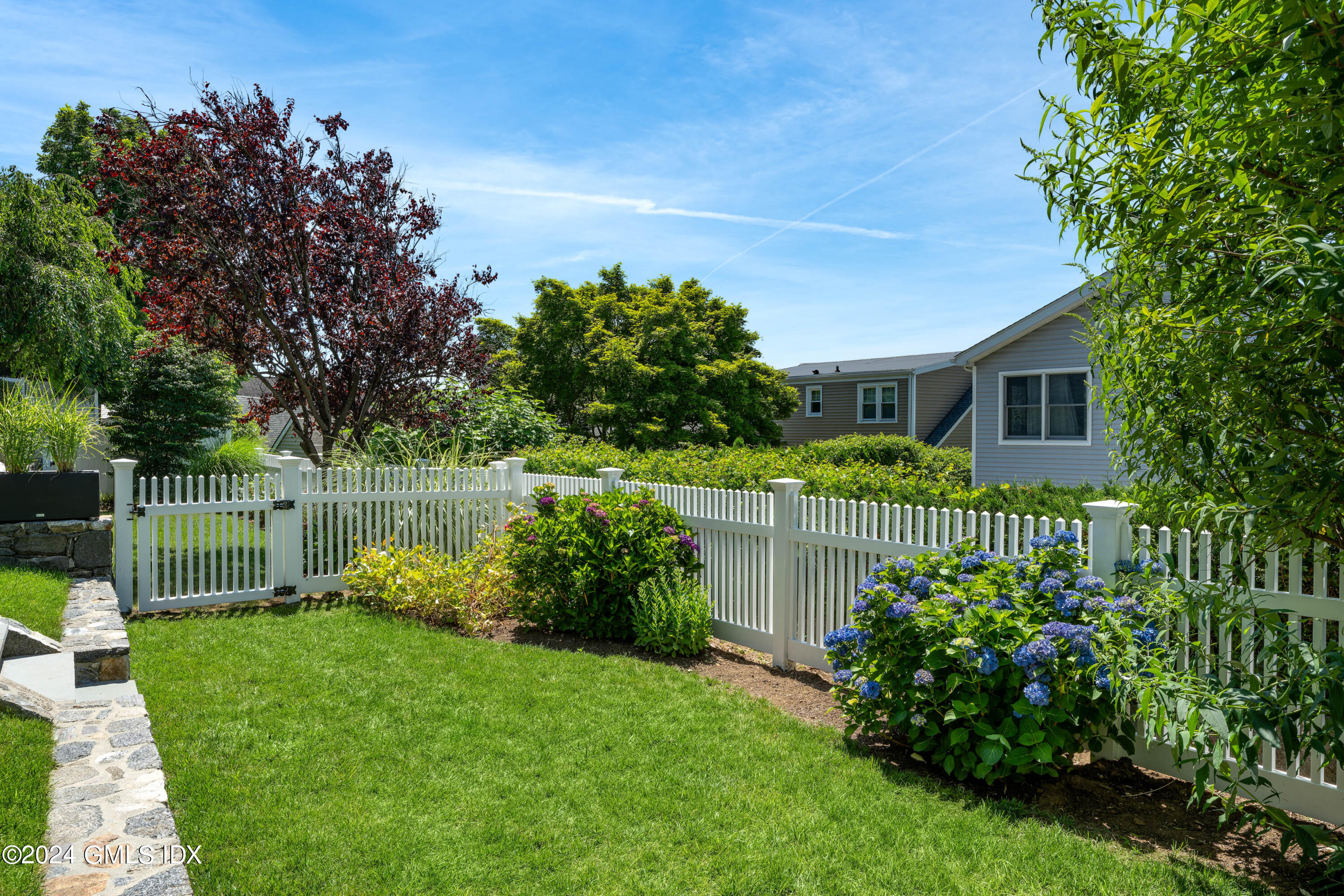 54 Valley Road, Unit B Cos Cob, CT 06807 - Photo 3 of 22 a front view of a house with a garden