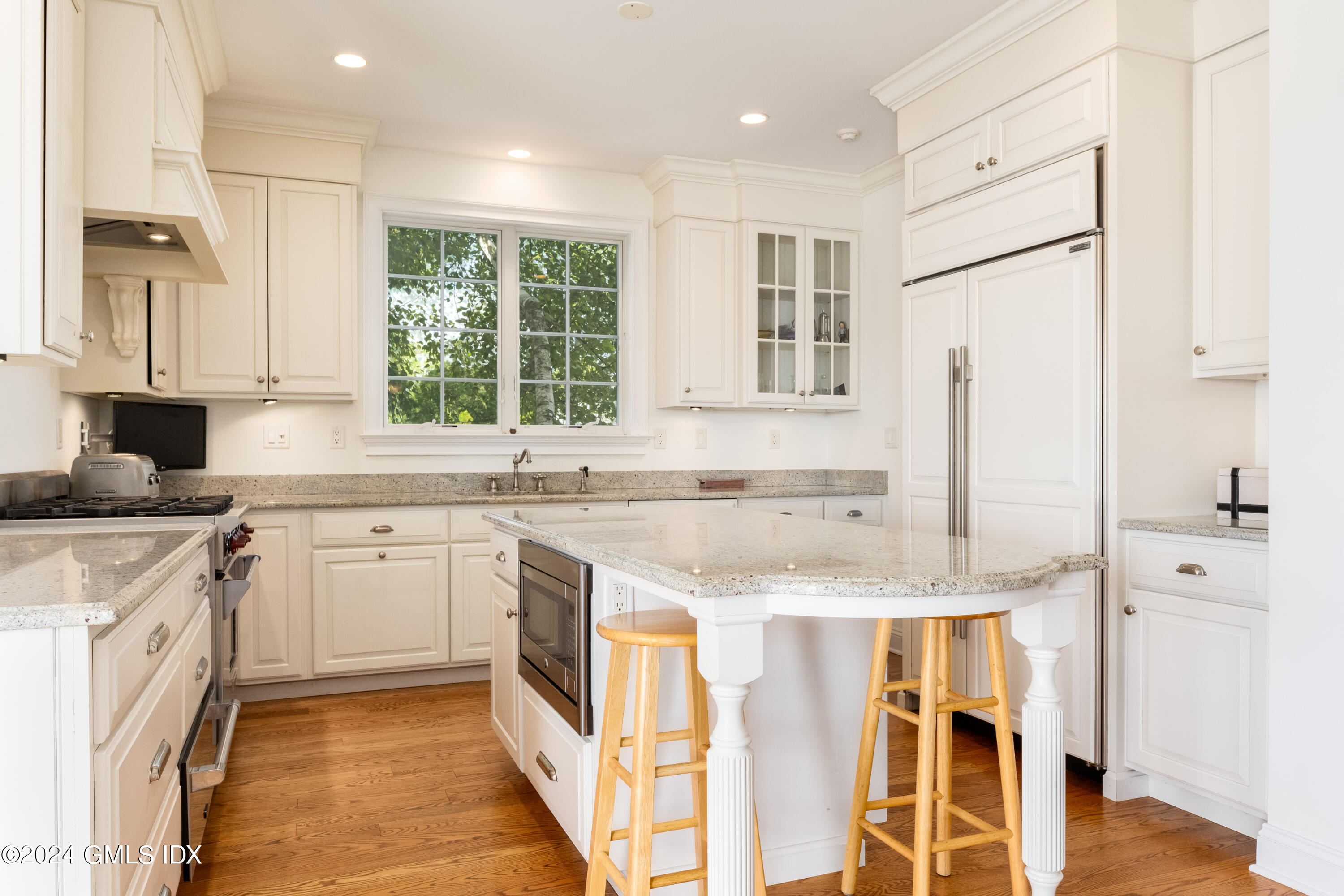 54 Valley Road, Unit B Cos Cob, CT 06807 - Photo 7 of 22 a kitchen with granite countertop white cabinets and white appliances