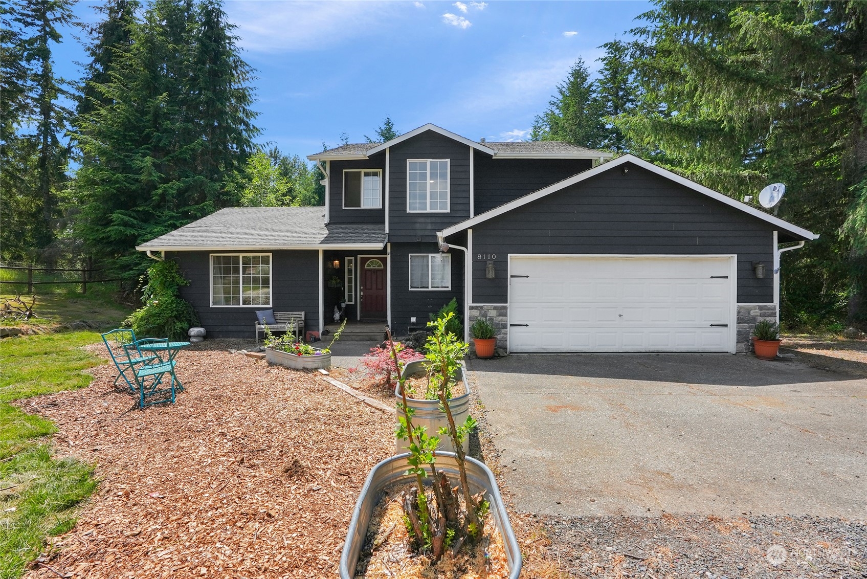 8110 Skinner Road Granite Falls, WA 98252 - Photo 1 of 30 a front view of a house with yard and patio