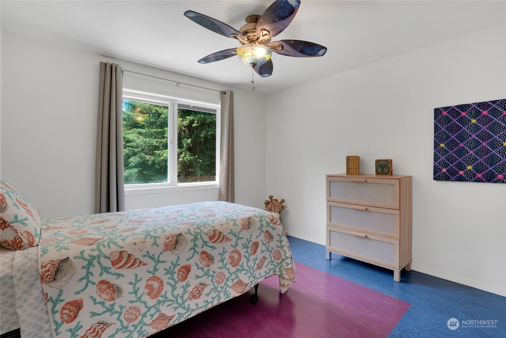 8110 Skinner Road Granite Falls, WA 98252 - Photo 16 of 30 a bedroom with a bed and a chandelier