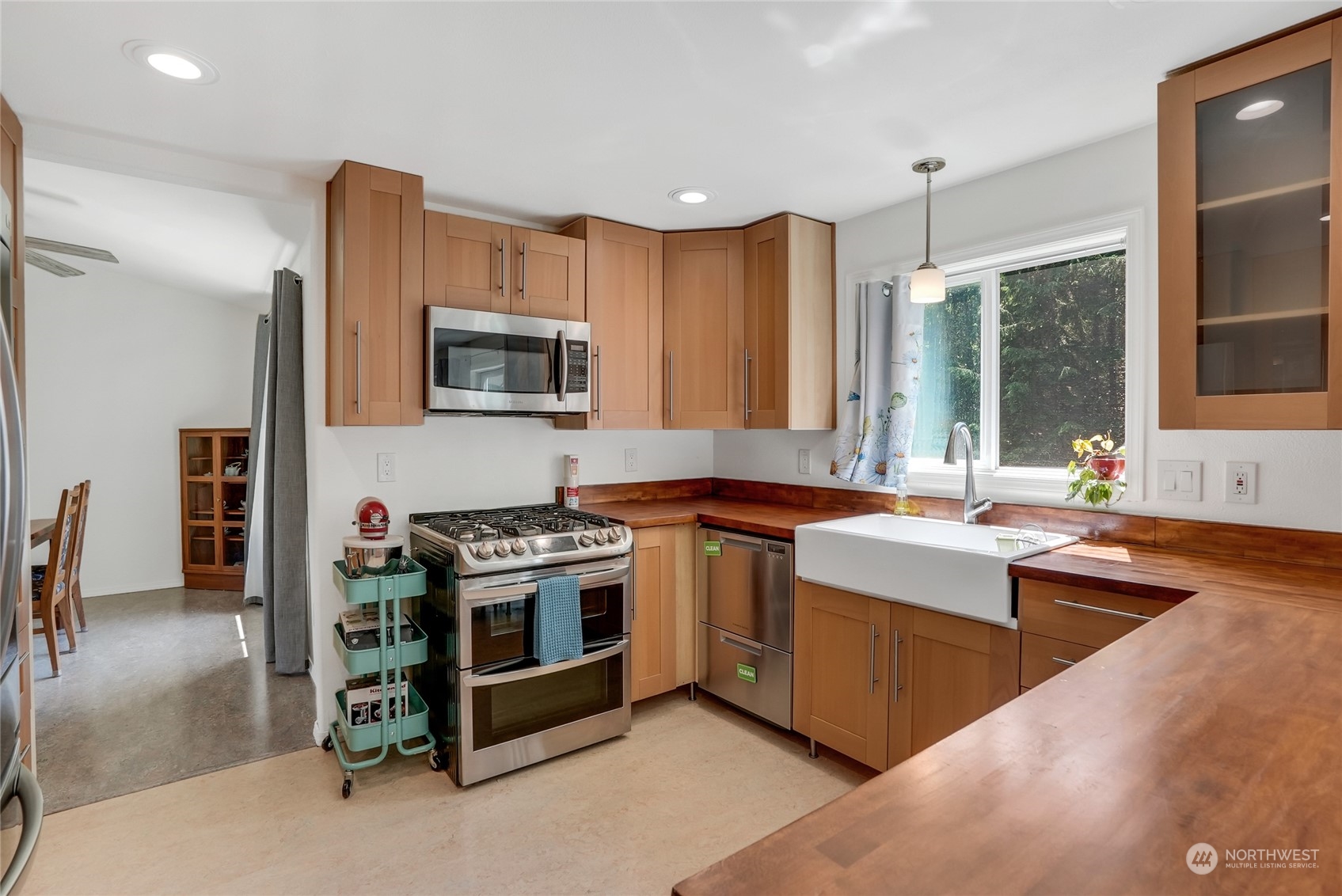 8110 Skinner Road Granite Falls, WA 98252 - Photo 5 of 30 a kitchen with stainless steel appliances granite countertop a stove a sink and a microwave