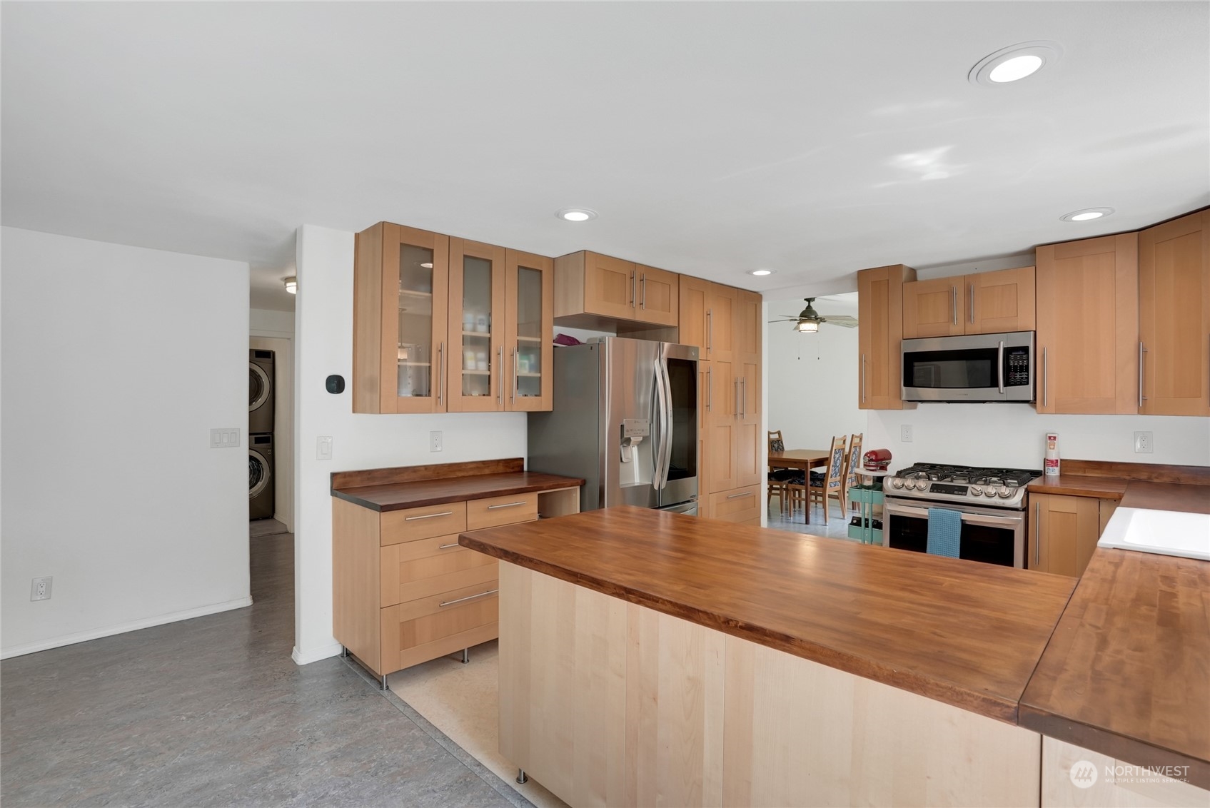 8110 Skinner Road Granite Falls, WA 98252 - Photo 8 of 30 a large kitchen with stainless steel appliances granite countertop a stove a sink and a refrigerator