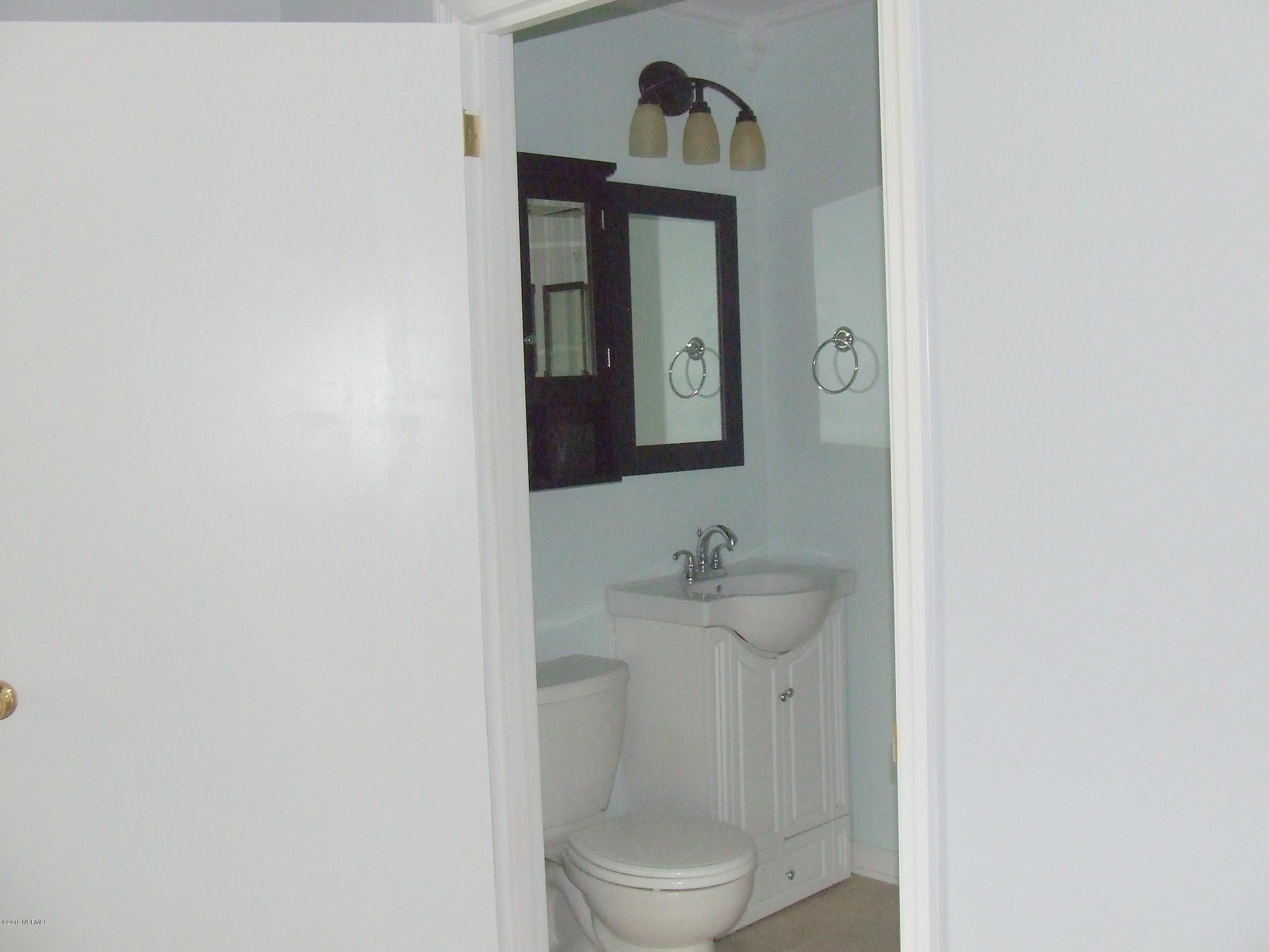 6058 Bethel Road Southeast Southport, NC 28461 - Photo 12 of 23 HALF BATH FROM THE MASTER BEDROOM