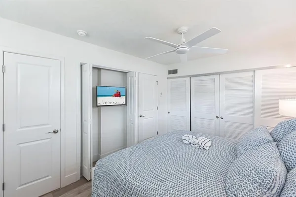 a bedroom with a large bed and a chandelier