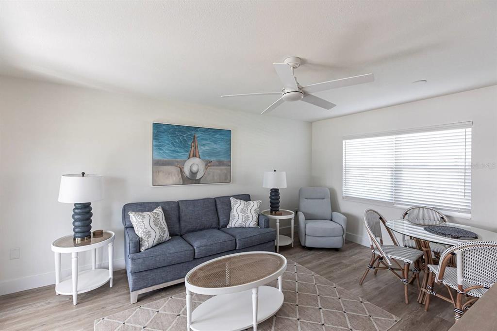 6020 Midnight Pass Road, Unit 5 Sarasota, FL 34242 - Photo 4 of 22 a living room with furniture a window and a table