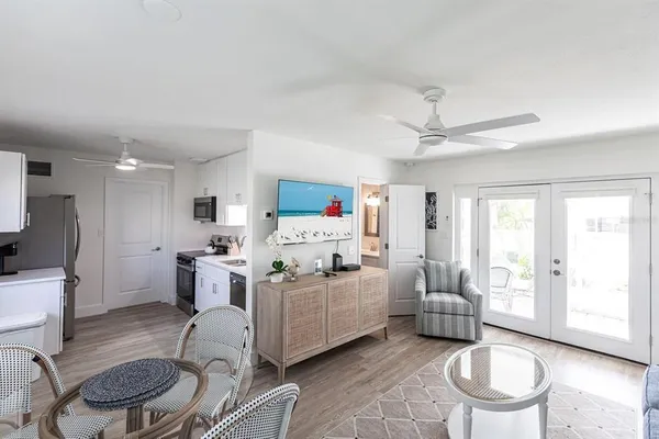 a living room with furniture a flat screen tv and a table