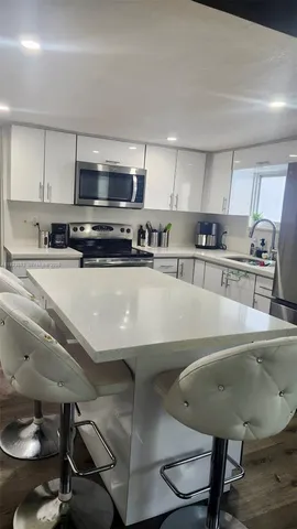 a kitchen with kitchen island stainless steel appliances lots of counter top space