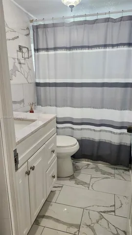 a bathroom with a sink toilet and vanity