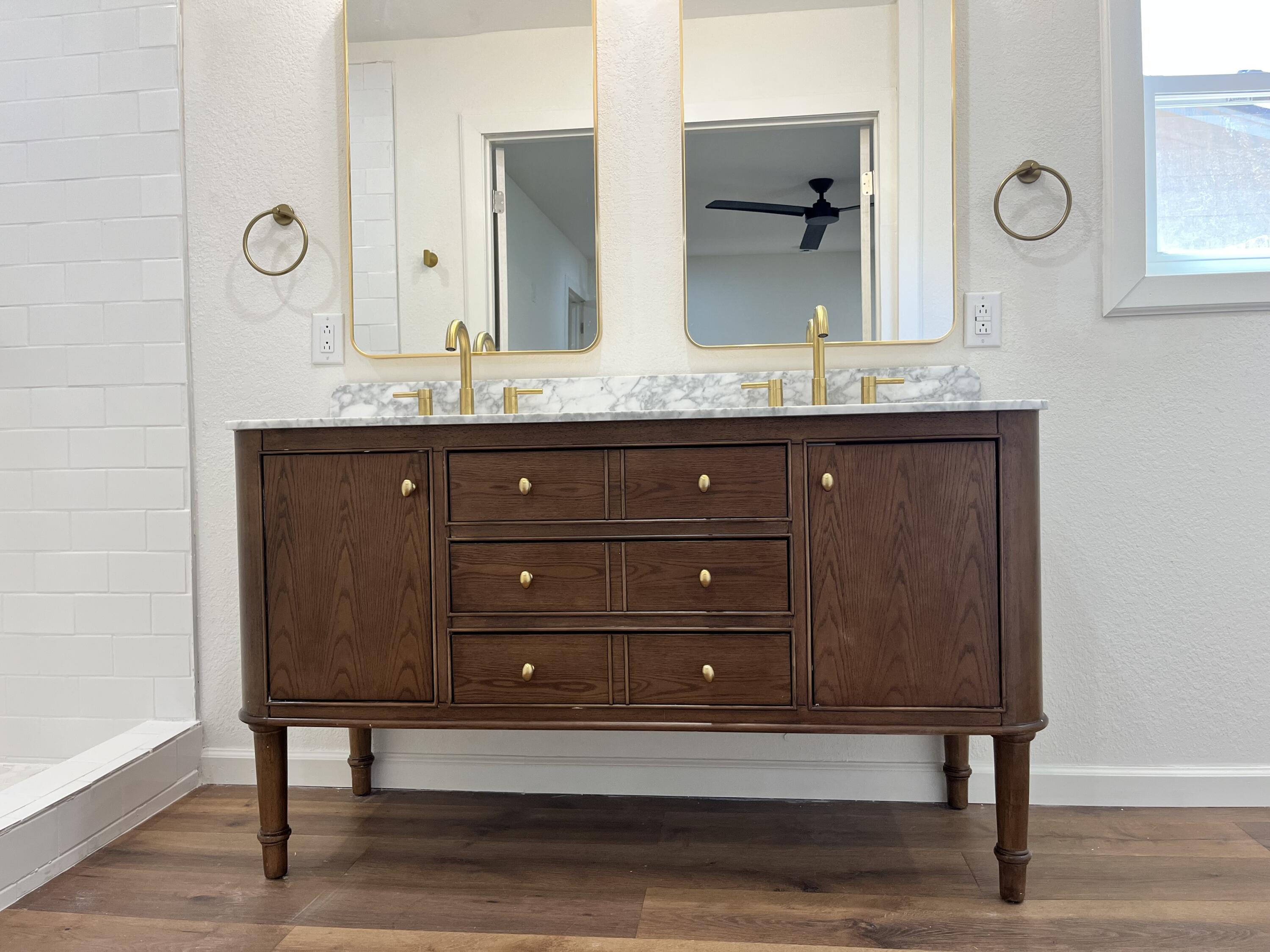 2620 78th Street Lubbock, TX 79423 - Photo 11 of 27 a bathroom with a granite countertop double vanity sink and mirror