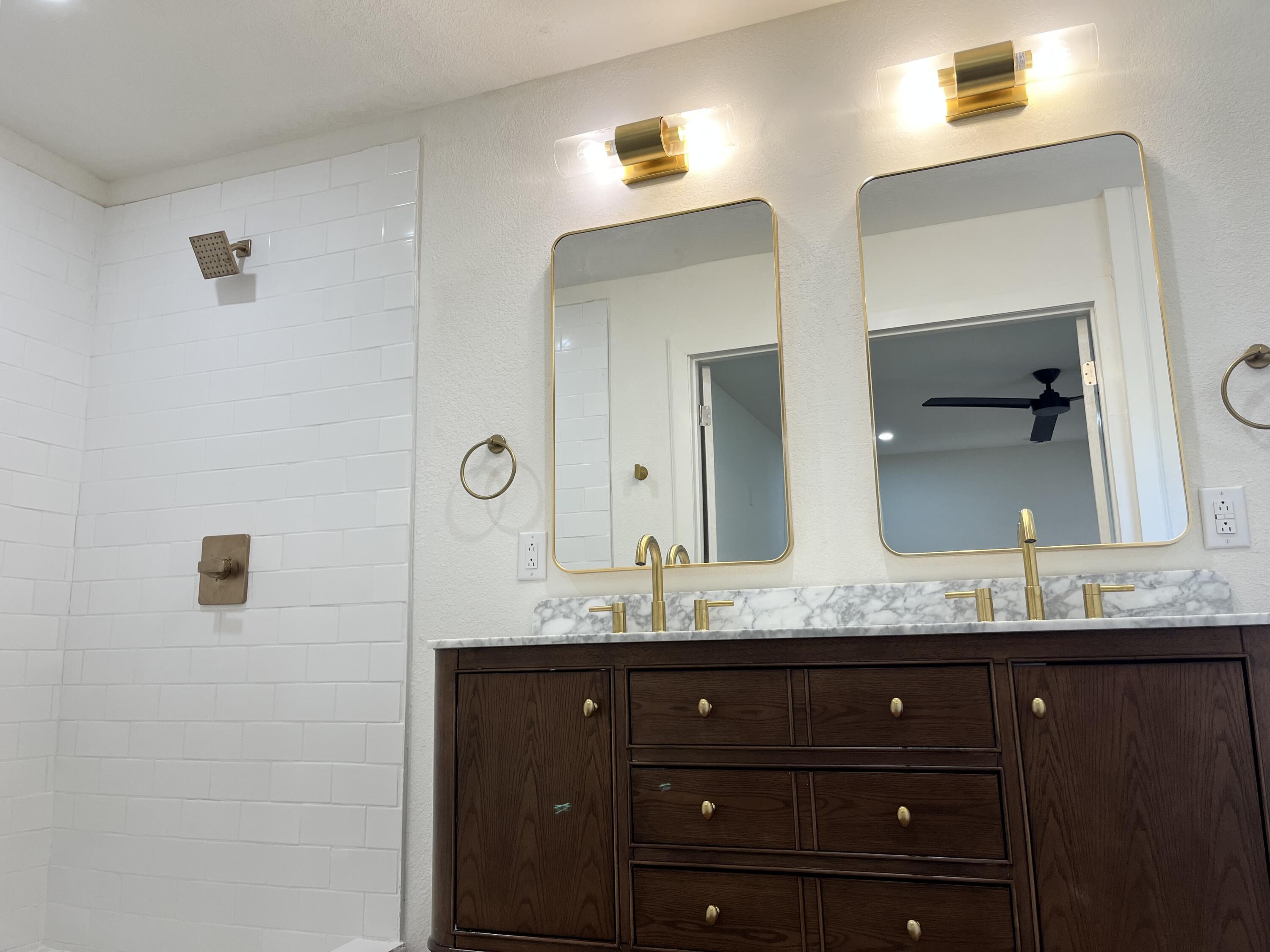 2620 78th Street Lubbock, TX 79423 - Photo 12 of 27 a bathroom with a granite countertop sink and a mirror