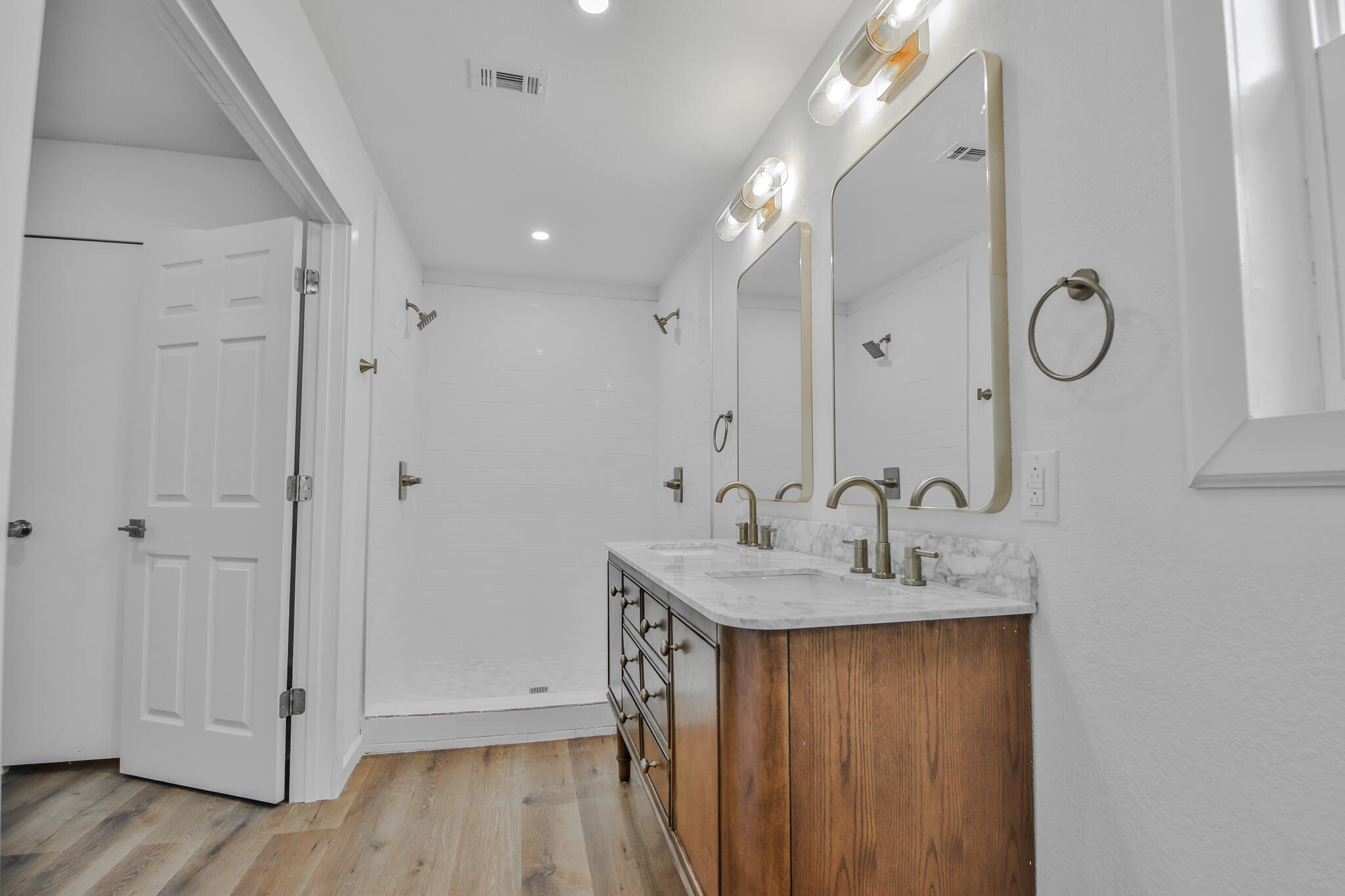 2620 78th Street Lubbock, TX 79423 - Photo 15 of 27 a bathroom with a granite countertop sink a mirror and shower