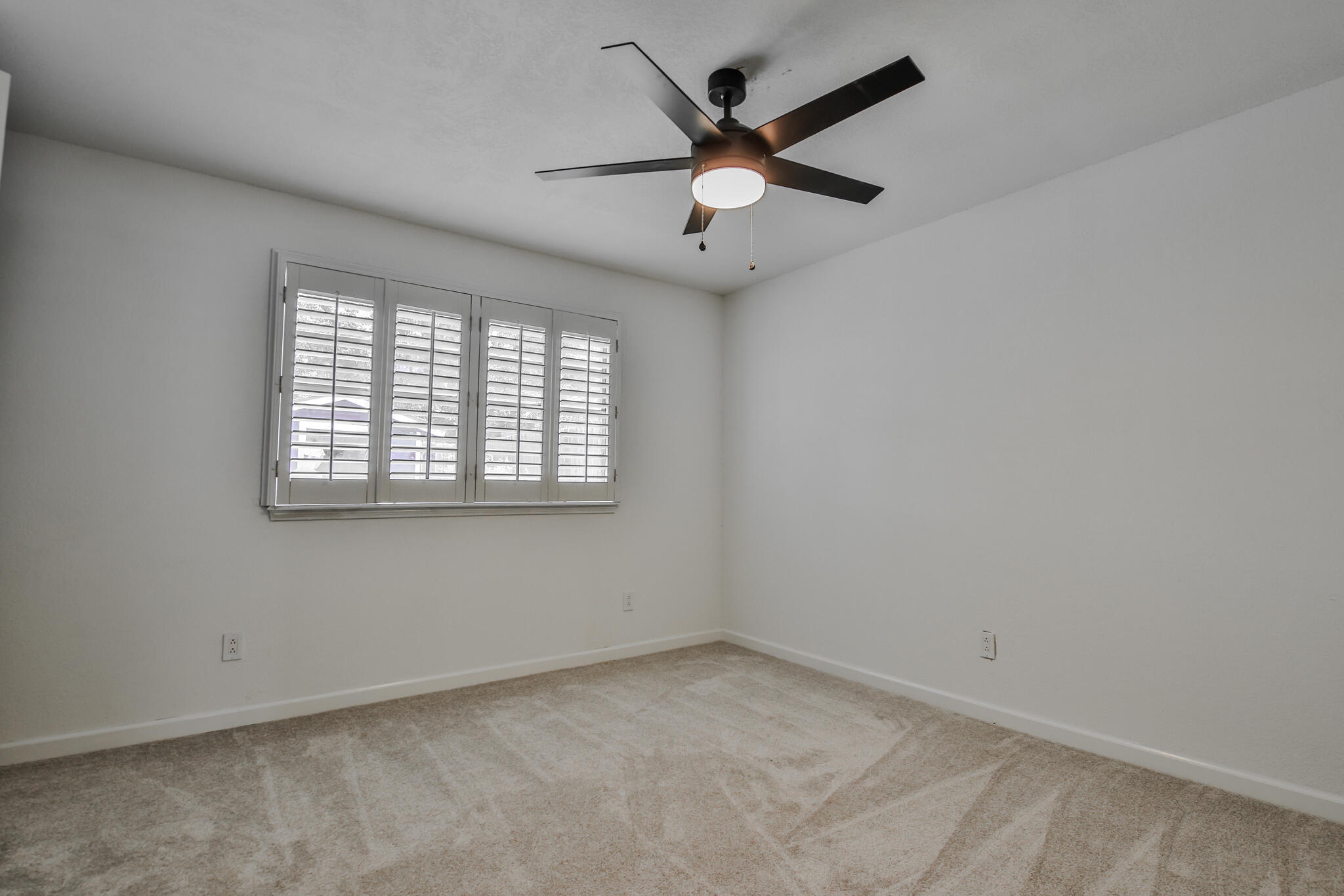 2620 78th Street Lubbock, TX 79423 - Photo 18 of 27 an empty room with a window and a fan