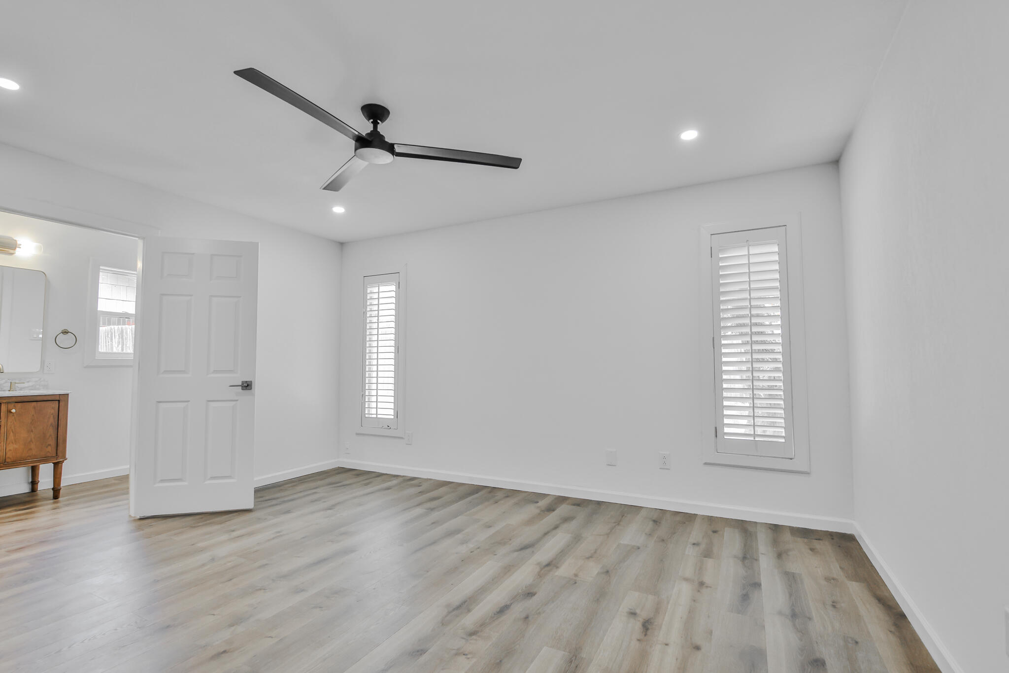 2620 78th Street Lubbock, TX 79423 - Photo 8 of 27 an empty room with wooden floor and windows